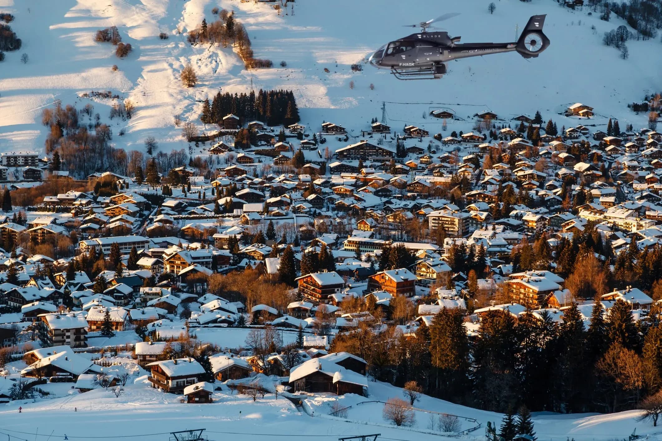 Helicopter flying over snowy Megève